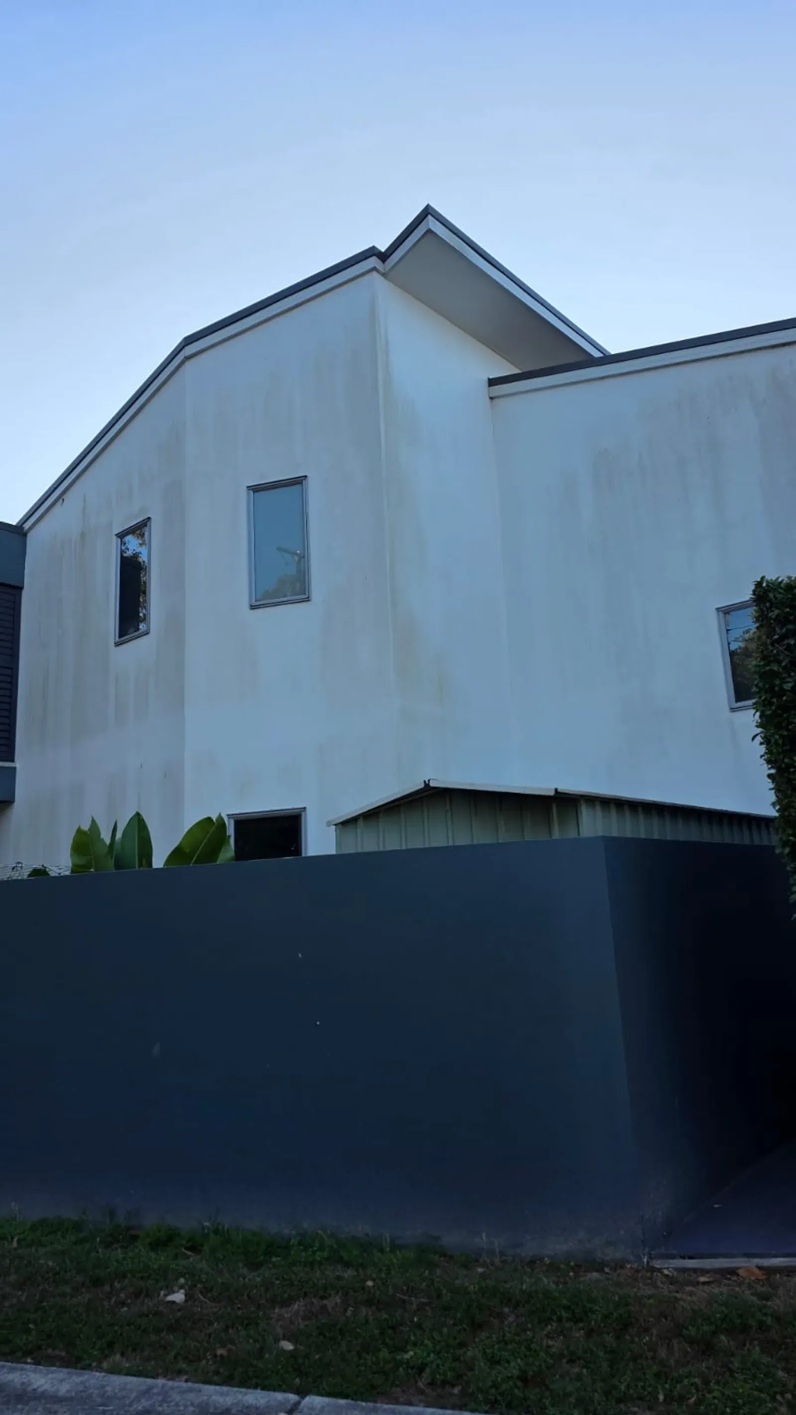 Before and after soft-wash house cleaning on Brisbane render exterior