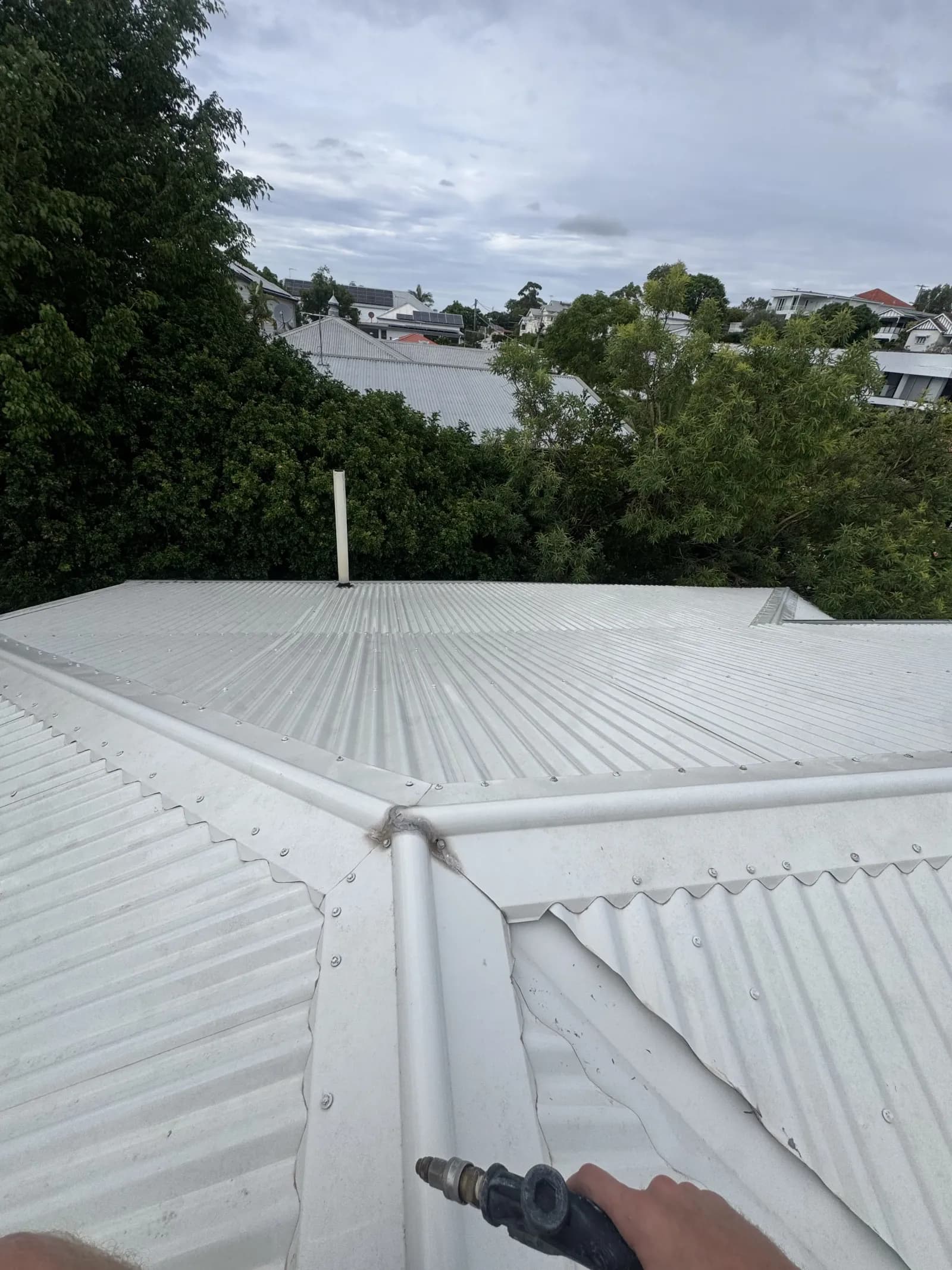 Before and after Colorbond roof clean on a Brisbane home